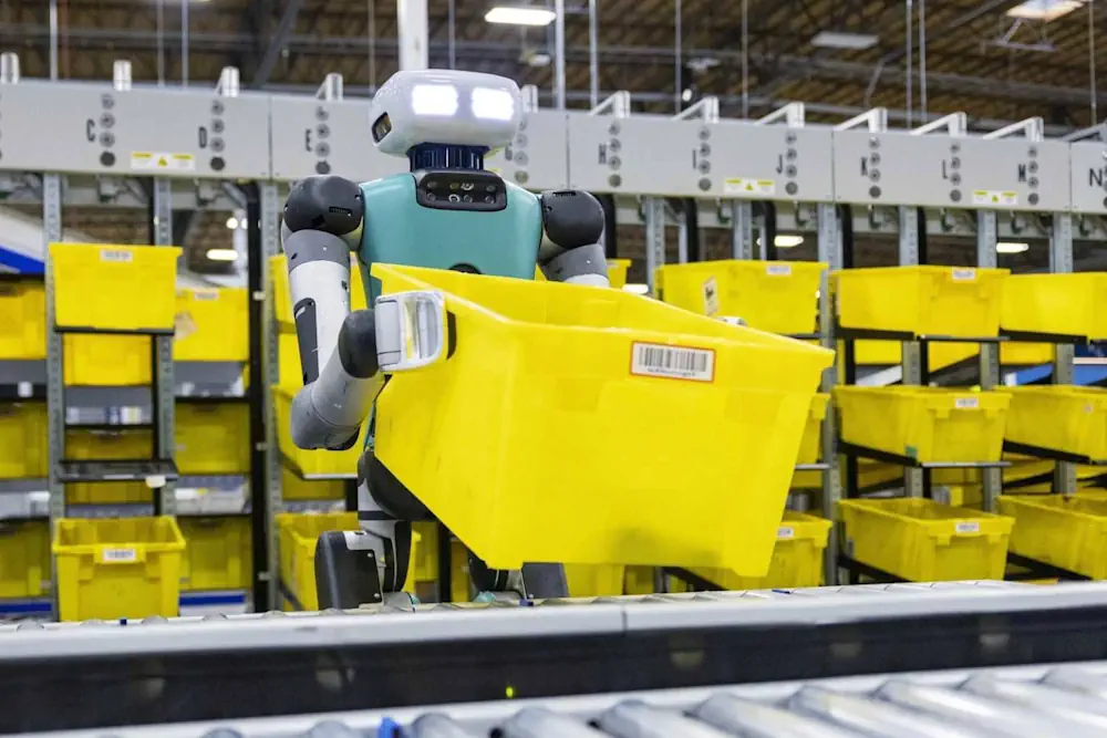 Un robot humanoïde Amazon transportant un bac dans un entrepôt