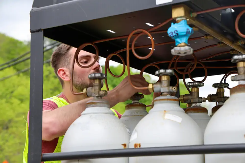 La technique consiste à utiliser un applicateur pour pulvériser sur le faisceau de l'acier alimenté en gaz comprimé, provenant de réservoirs comme ceux présentés ici. Des pulvérisations répétées créent des couches multiples, rétablissant l'épaisseur et d'autres propriétés structurelles.