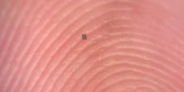 A microrobot, fully integrated with sensors and a computer, small enough to balance on the ridge of a fingerprint.