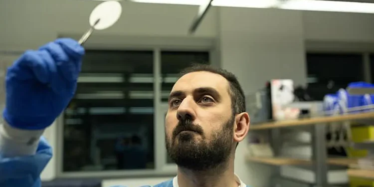 UBC Okanagan doctoral student Mahmoud Babalar examines a sample of the dual-layer modified matrix membrane that can help