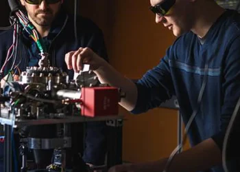 Robert Niffenegger (à gauche) et Christopher Caron au laboratoire de calcul quantique et de photonique sur ions piégés de l'UMass Amherst