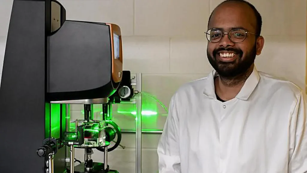Surendra Padamata, graduate student in physics at Penn State, with the device used in new research that showed a suspens