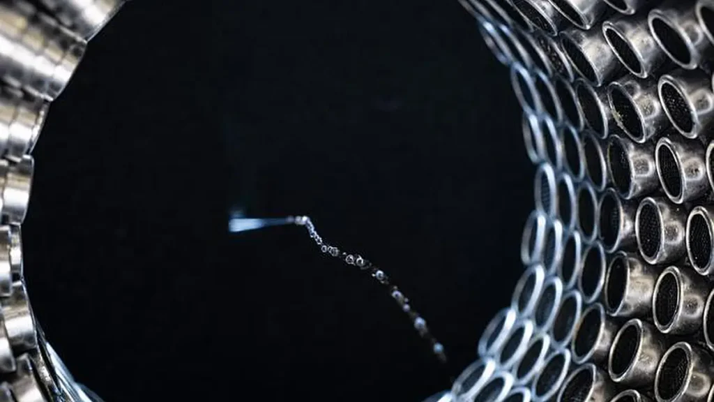 De l'eau s'écoulant à travers un tube à ultrasons alimenté par 256 haut-parleurs.
